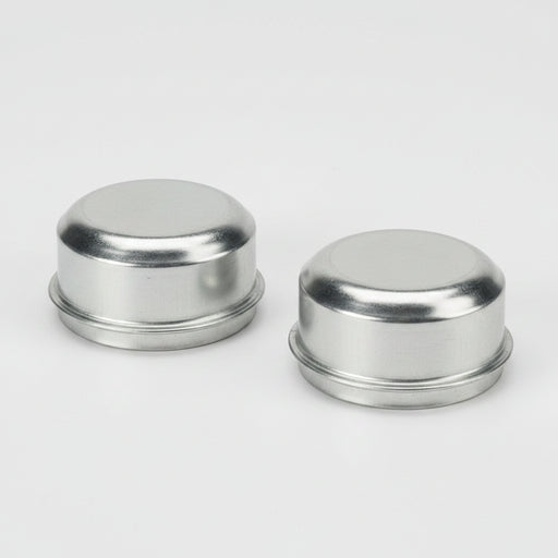 Two round steel dust caps with a silver finish, designed for trailer hubs.